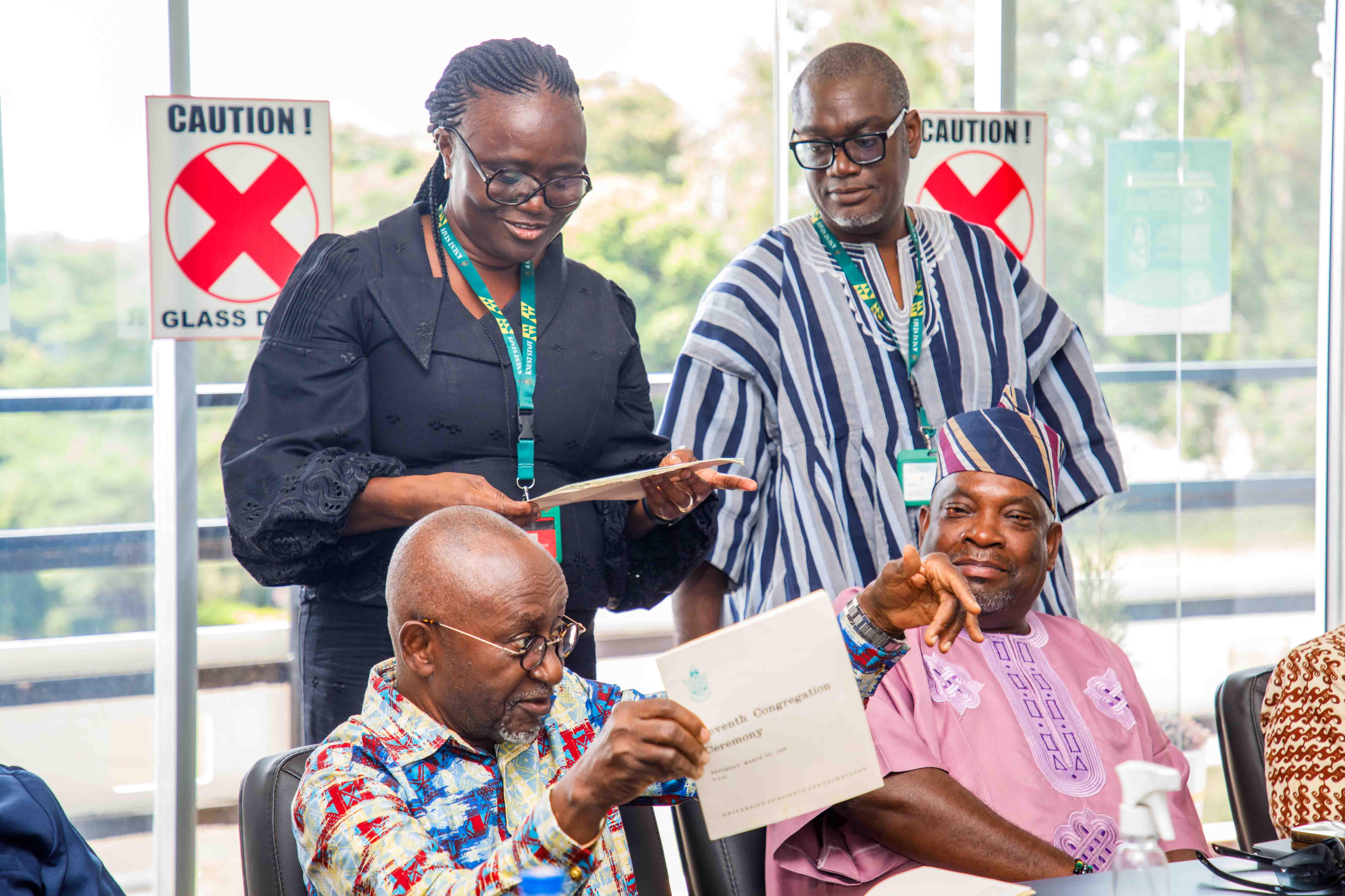 Dr. Kwaku Aning presents his 1968 Examinations and Congregation booklet to KNUST